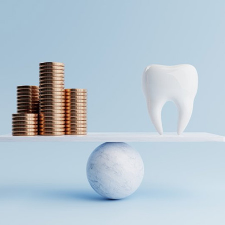 Tooth balanced against stacks of coins