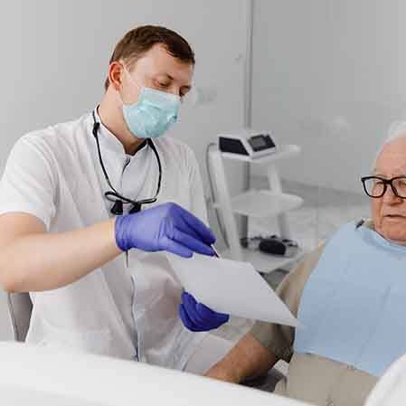 older patient getting an implant denture consultation