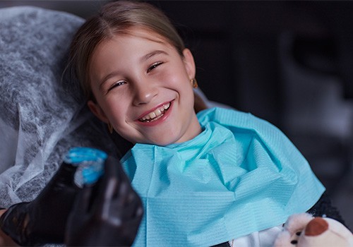Young patient in Medina Valley smiling in the dentist chair