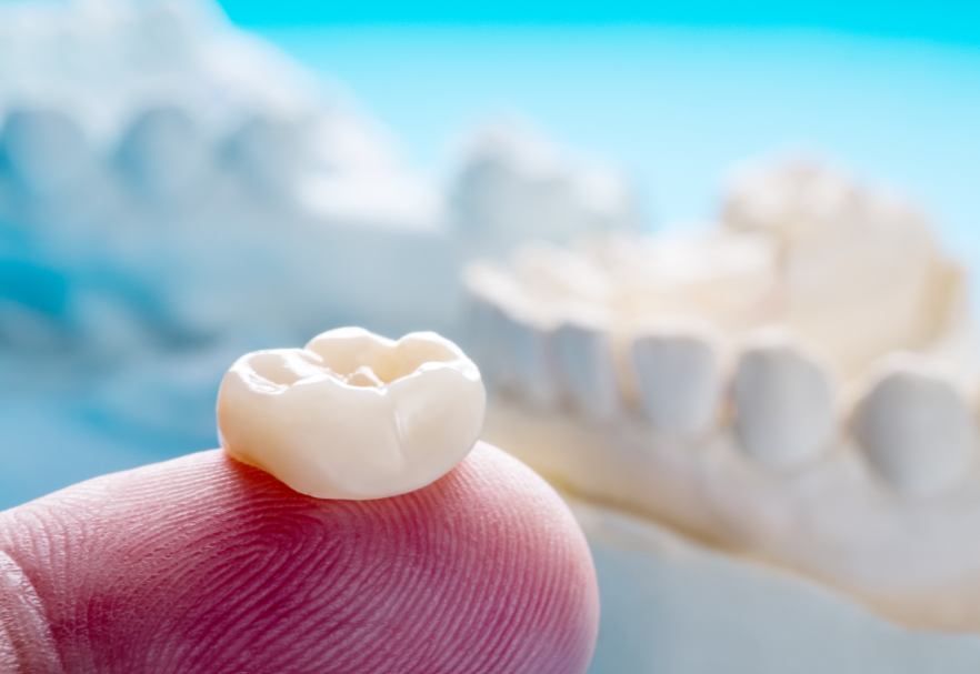 Dental crown on fingertip